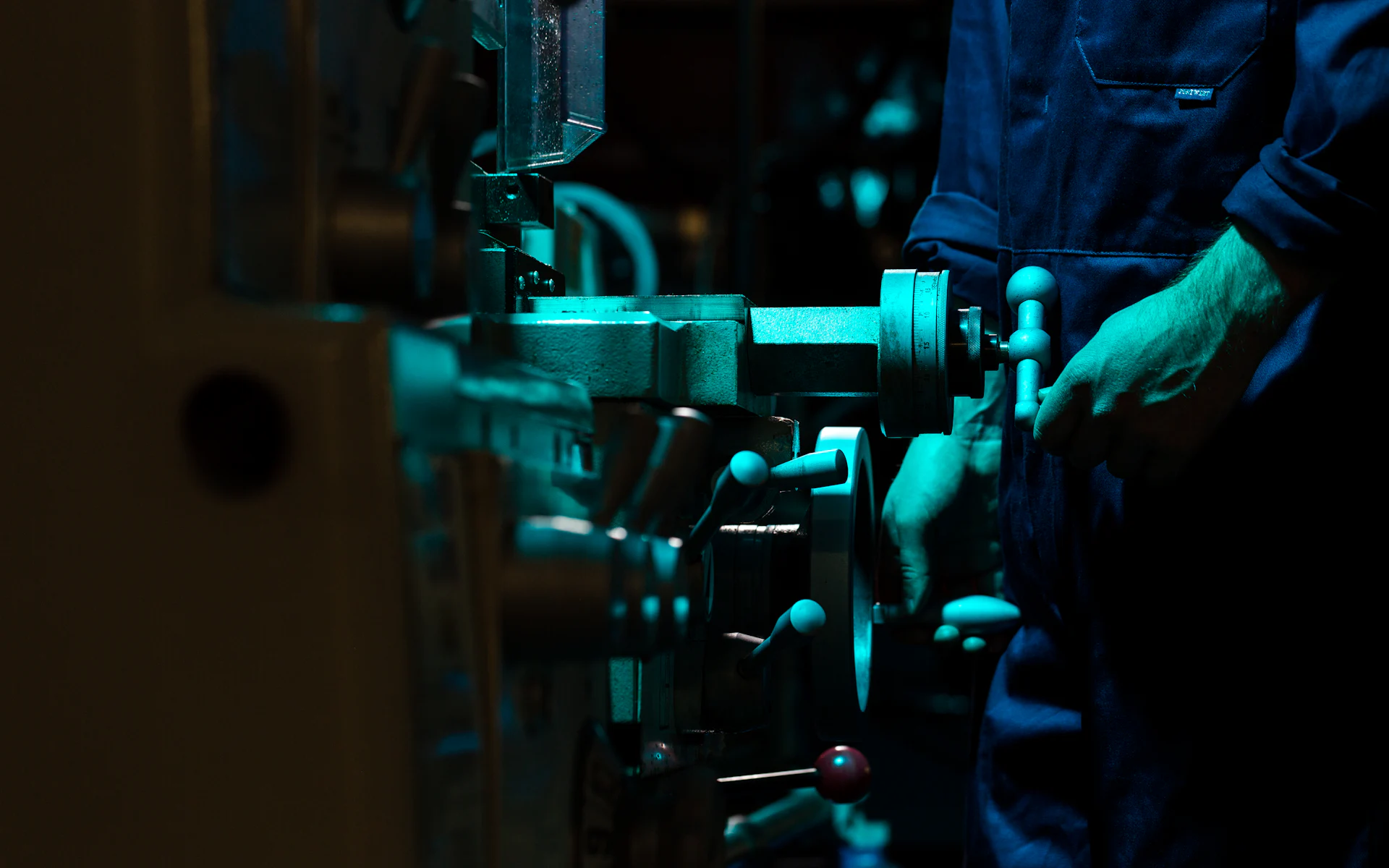 Machinist operating equipment in a machine shop